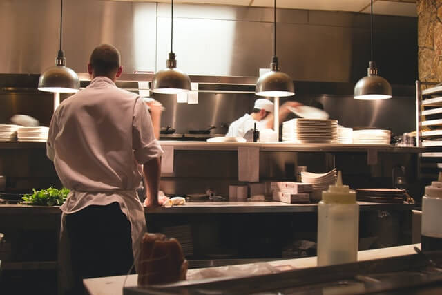 Inicio chef standing in restaurant kitchen